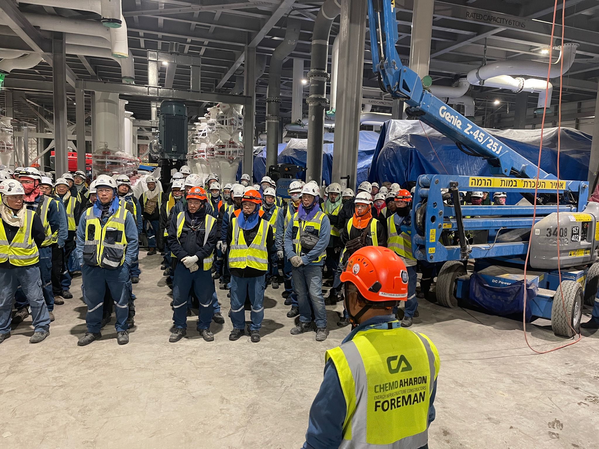 Foreman leading safety briefing in FAB facility